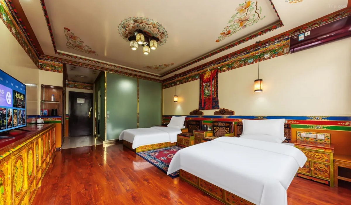 Spacious Tibetan twin guest room with wooden flooring and painted ceiling