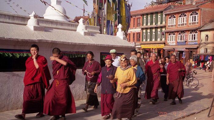 Tibetan monks do the kora round Bodhnath. 