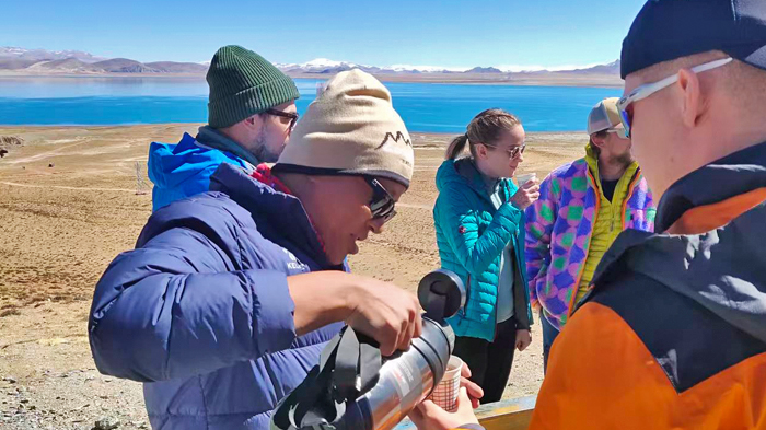 Our local Tibetan guide offers guests a warm cup of Tibetan sweet tea