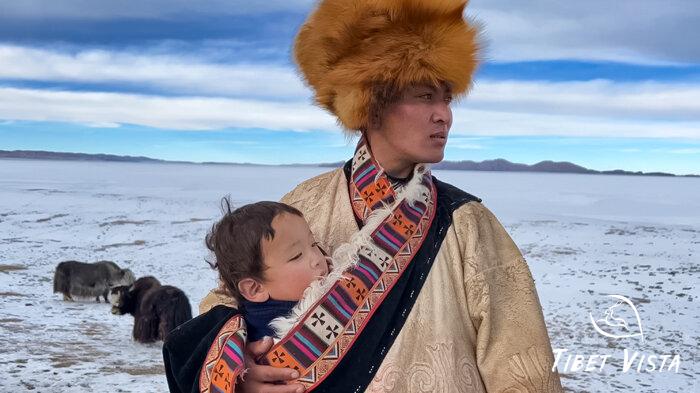 A caring Tibetan man holding his kid