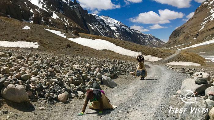 Pilgrims prostrating in deep devotion around holy Kailash