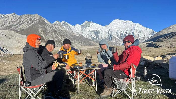 Our guests are enjoying a cozy meal beside the warm tent in the serene Gama Valley