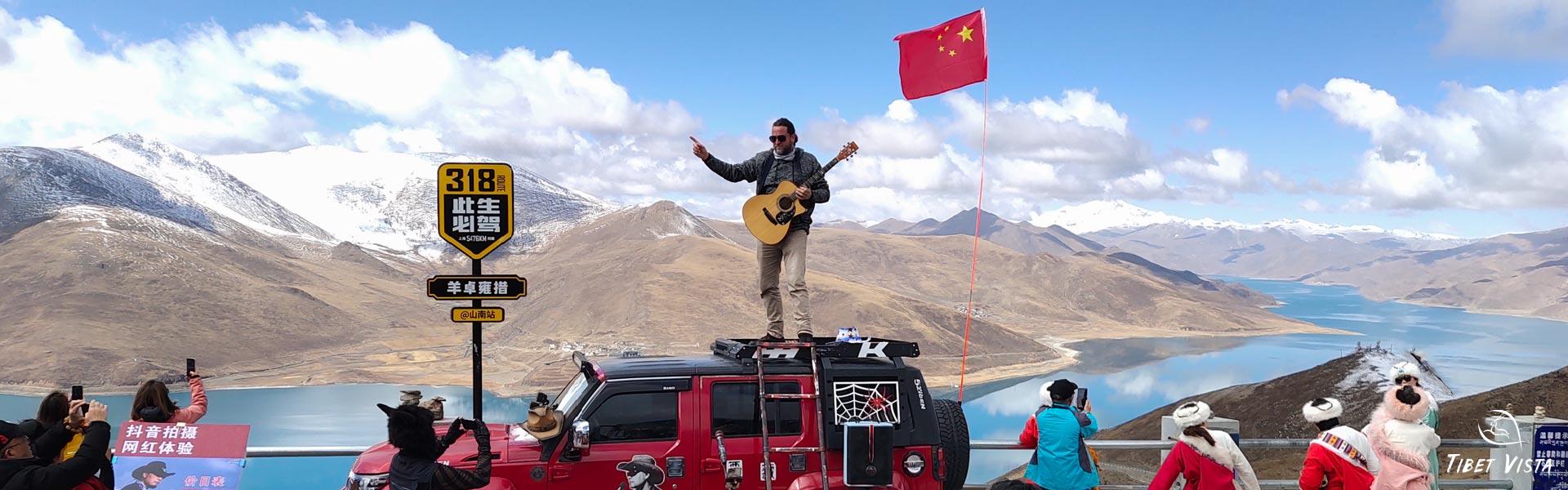 guests play guitar at yamdrok lake