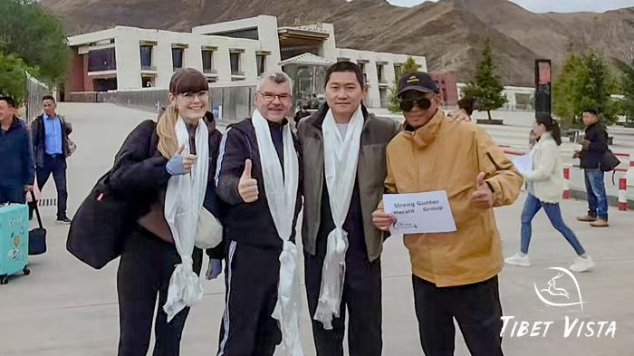 Our local Tibetan guide greets newly-arrived guests at Lhasa Railway Station with an auspicious Hada