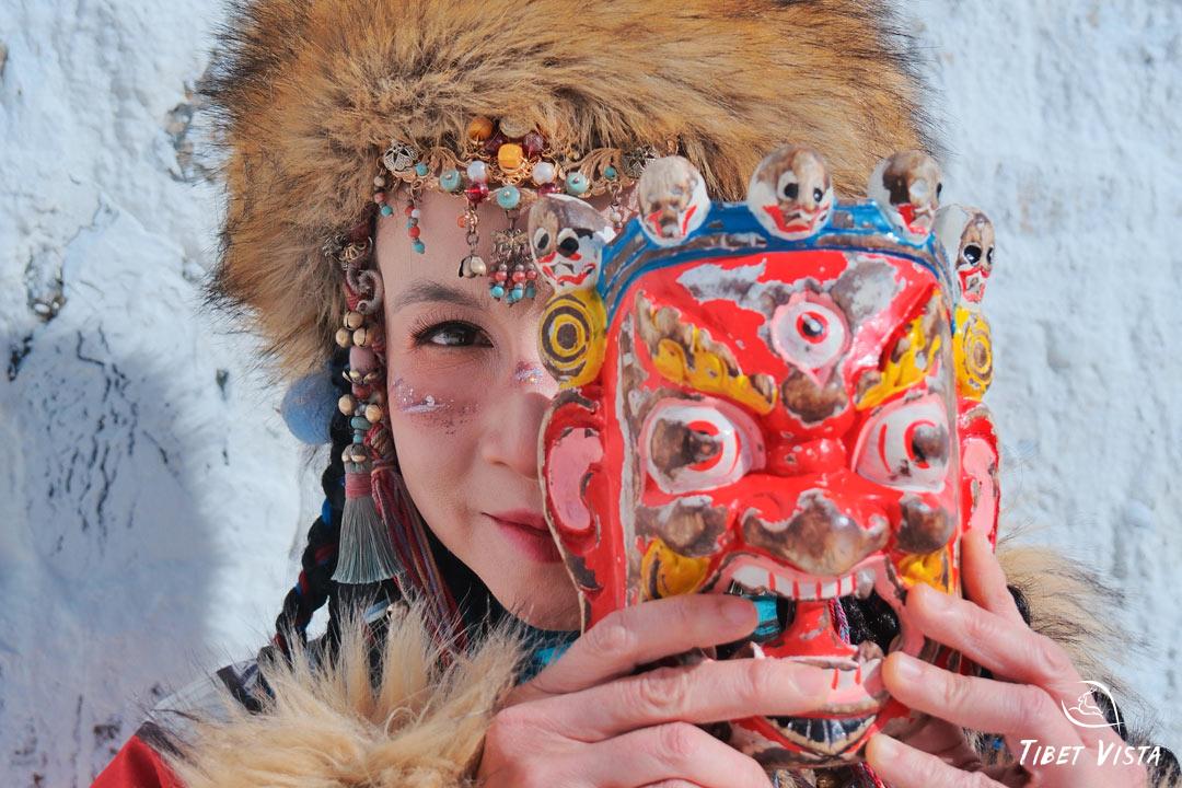 Pose for photos with Tibetan masks