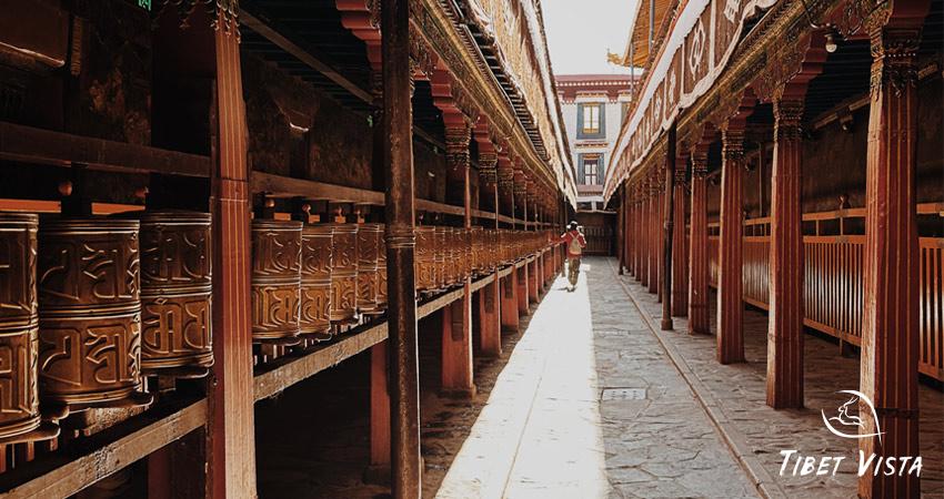 Spin Tibetan prayer wheel at Jokhang Temple in Lhasa