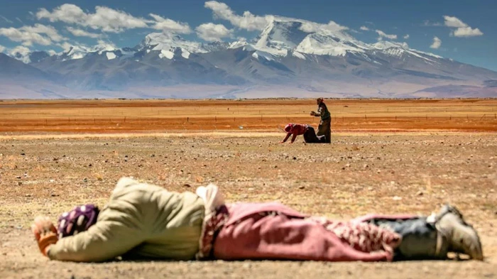 Tibetan Pilgrims Prostrate Themselves in Tibet