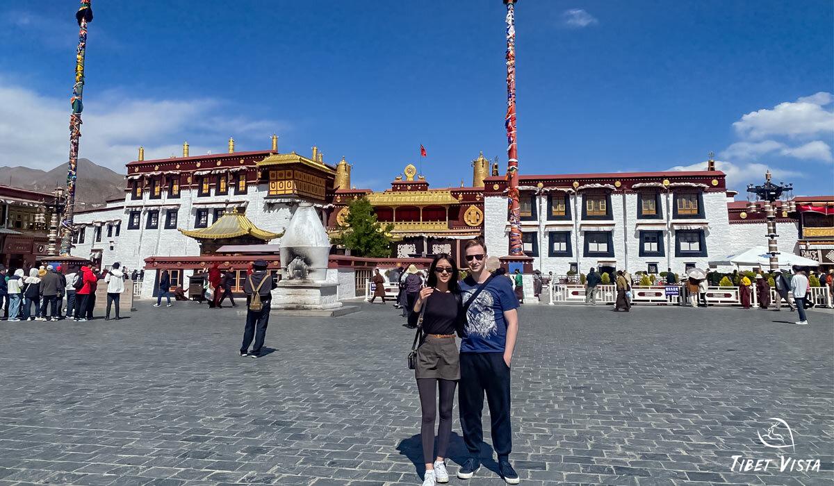 young couple visit jokhang temple front entrance