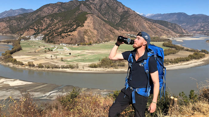 Foreign traveler drinking safe purified water in Tibet