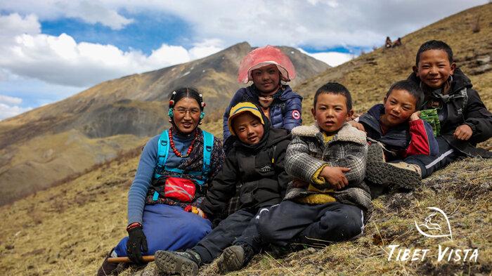 Tibetan children follow their parents