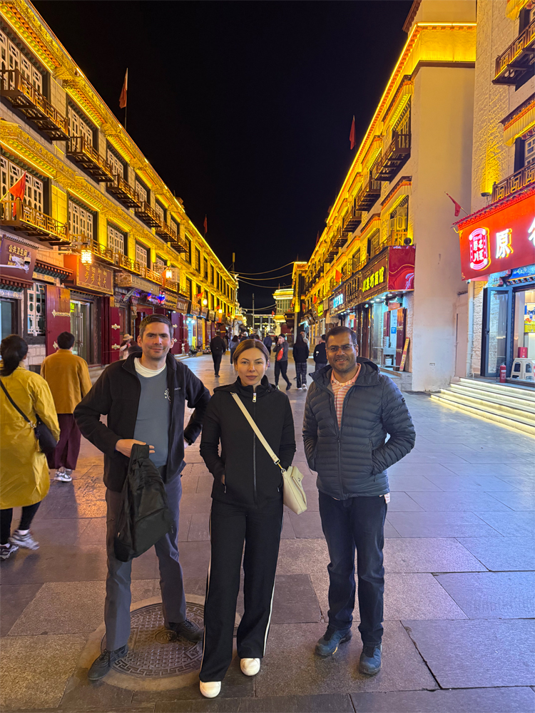 friends walking on Barkhor Street at night