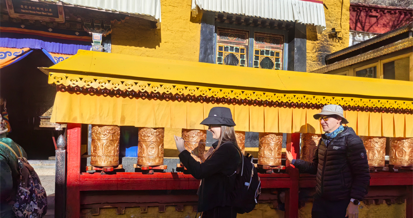 Travelers spinning prayer wheels at Barkhor Street in Lhasa