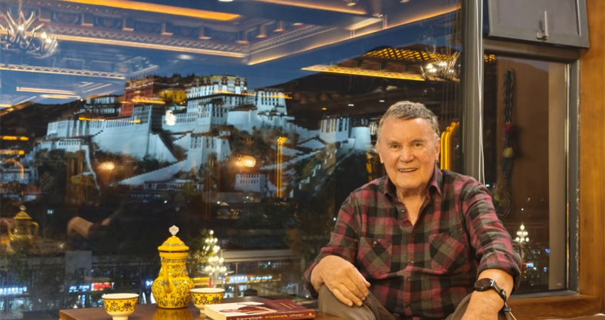 Traveler enjoying dinner with Potala Palace night view in Lhasa