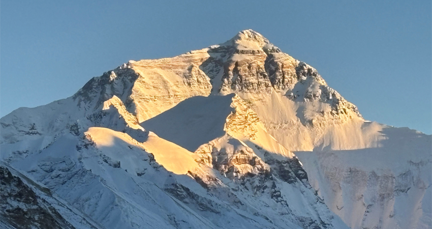 golden summit of mount everest at sunset
