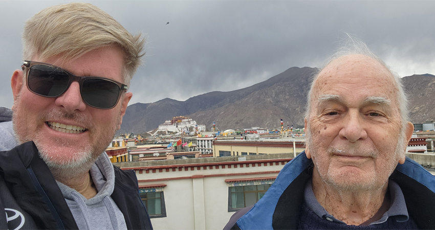 Father and son with Potala Palace in Lhasa Tibet
