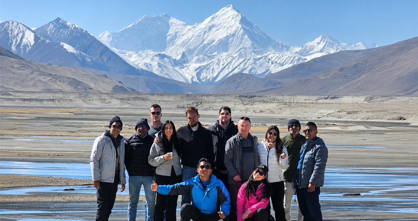 Tibet tour group posing with Mount Everest at Dinggye Xilin Viewpoint