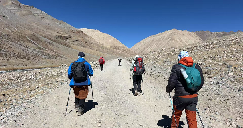 Travelers trekking high-altitude mountain trail