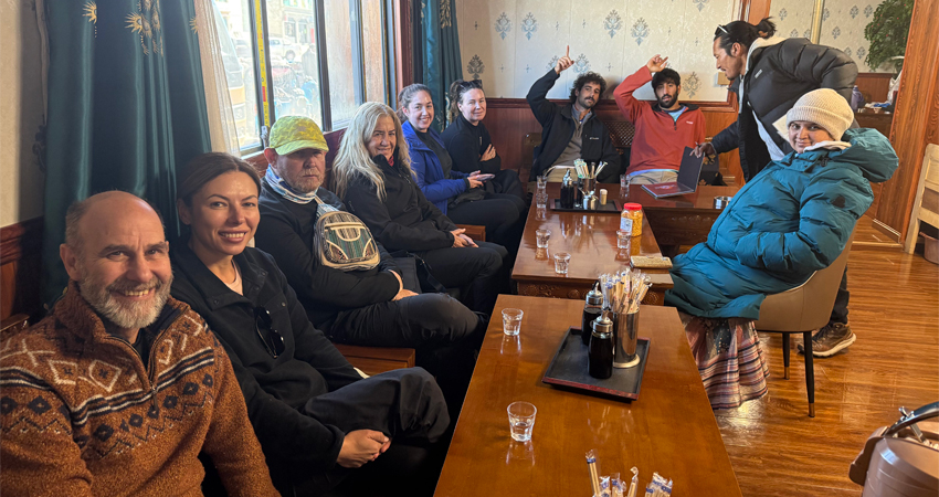 Group of hikers waiting for local cuisine indoors