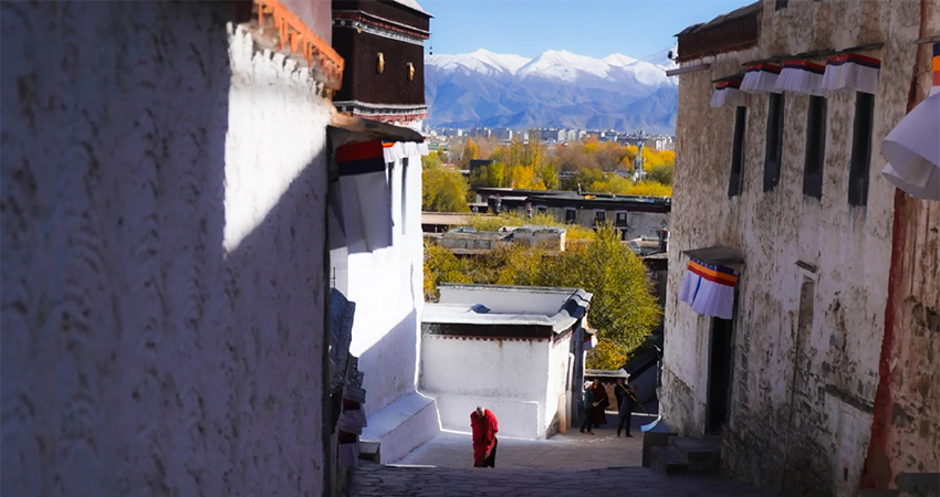 Monk in red robes at Tashilunpo Monastery Shigatse