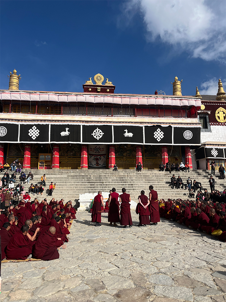 Drepung Monastery monks debate courtyard Lhasa Tibet