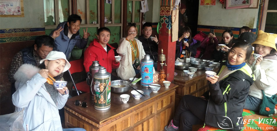 Enjoying noodles and sweet Tibetan tea at a local house in Chuxi Village