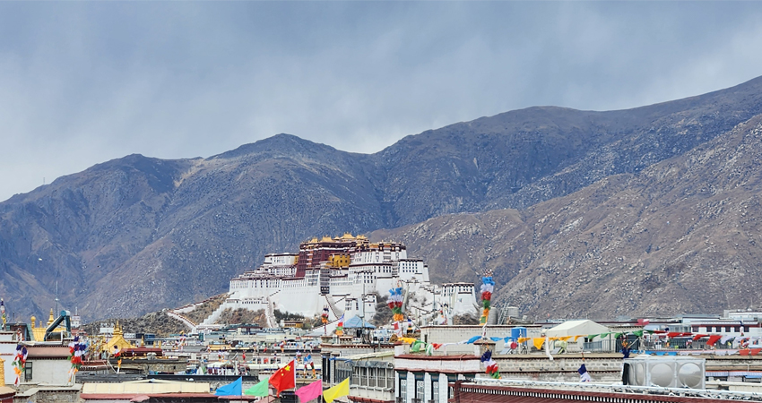 Majestic Potala Palace in Lhasa with mountains in background