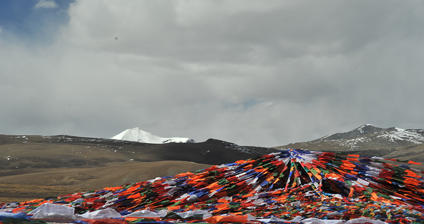 Colorful Tibetan prayer flags on high mountain pass