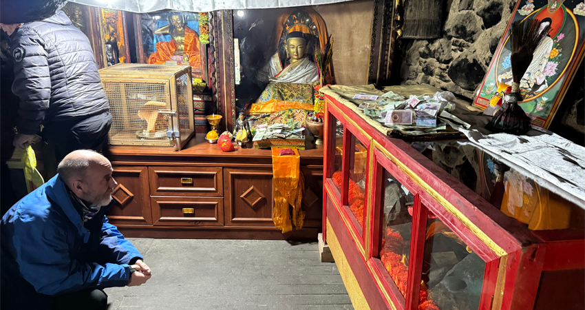 praying before Milarepa statue in Tibet