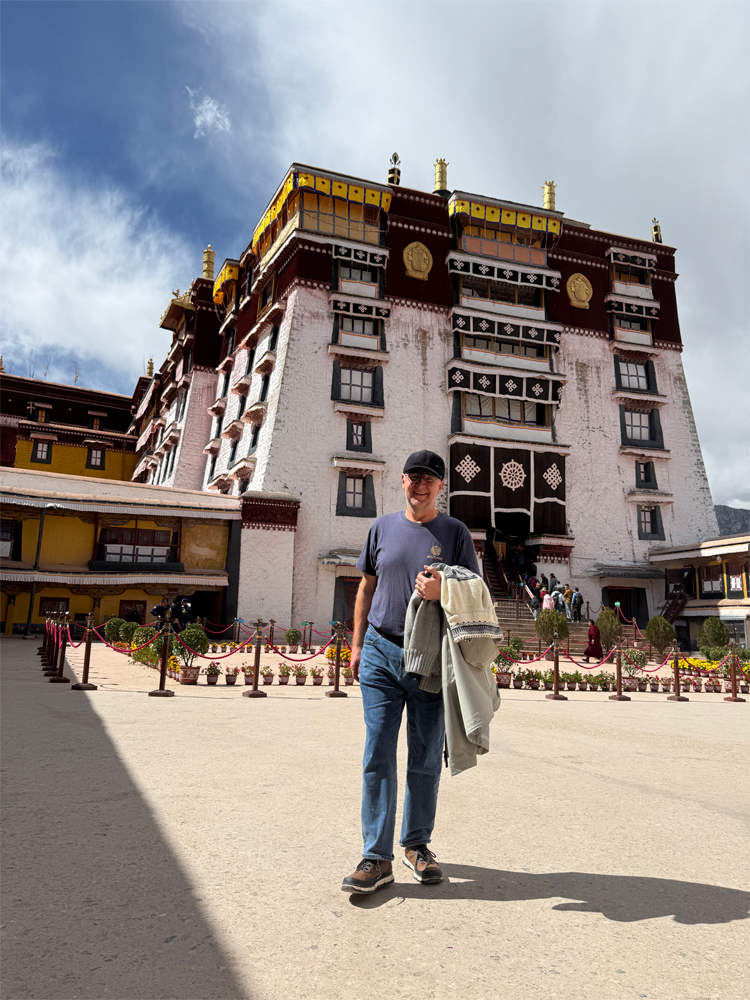 man in front of White Palace Potala