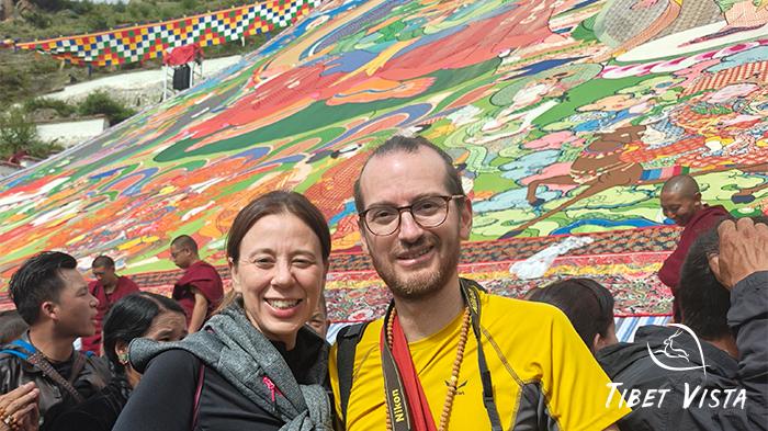 Our beloved guests visit in front of giant Buddha Thangka.