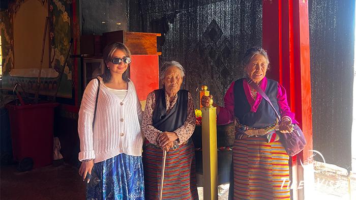Taking photos with local Tibetans during Shoton Festival.
