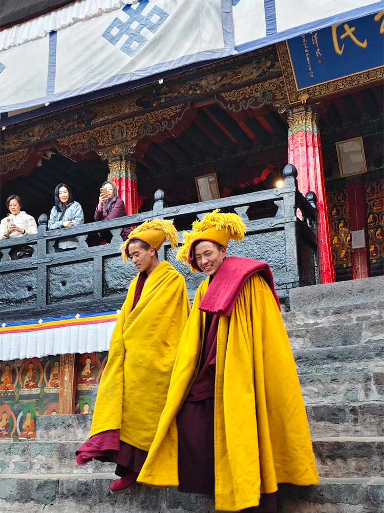 Monks in yellow robes at Tashilhunpo Monastery in Tibet