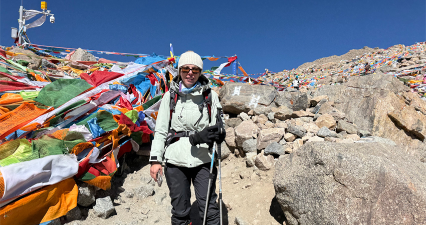 traveler with prayer flags on mountain