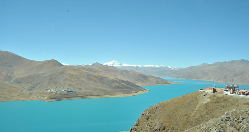 Yamdrok Lake turquoise water with snow capped mountains