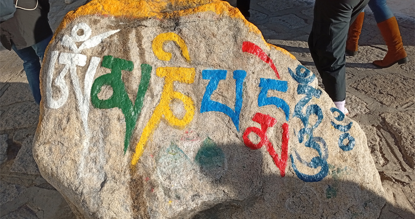 Buddhist mantra painted on rock Tibet