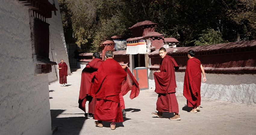 Tibetan monks walking inside Drepung Monastery in Lhasa