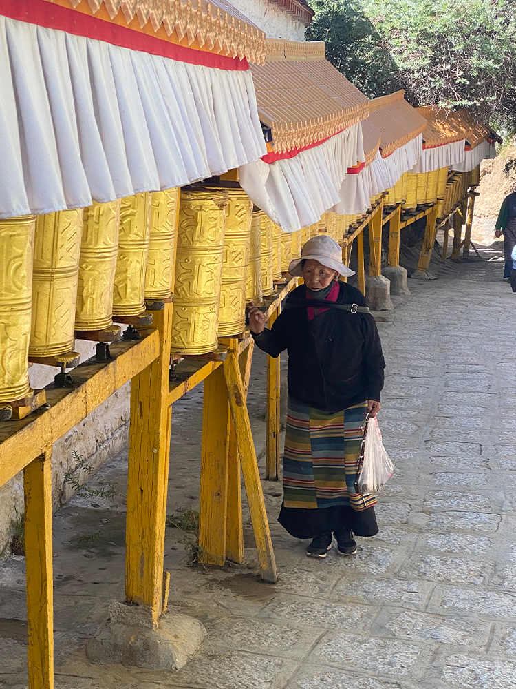 Tibetan pilgrims walking kora path in Tibet