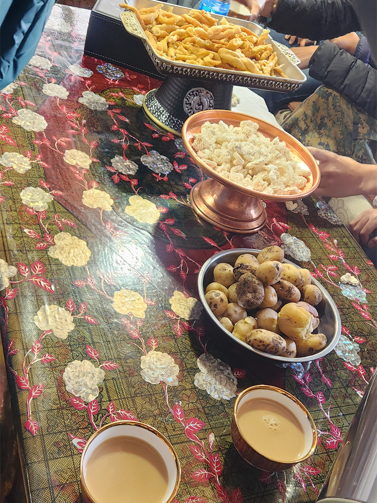 Tibetan sweet tea with traditional snacks on table