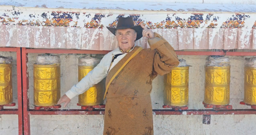Traveler in traditional Tibetan dress posing in Lhasa