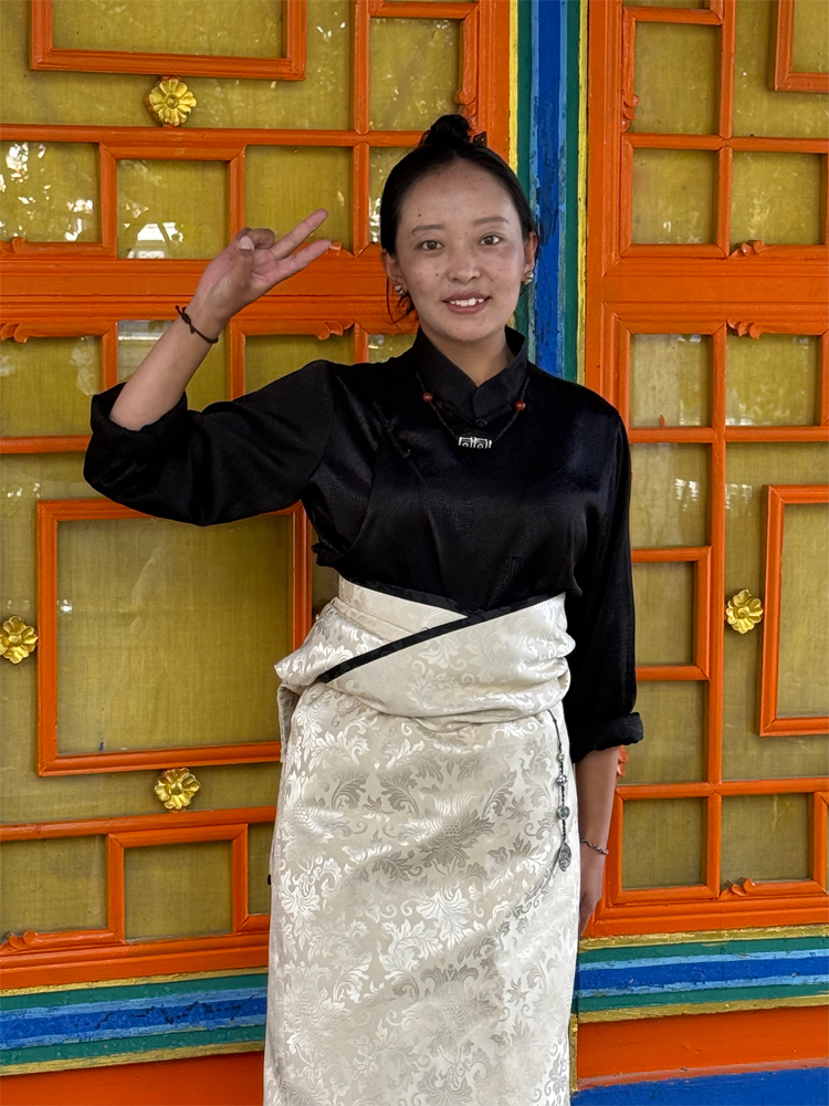 Tibetan waitress in traditional attire in Lhasa