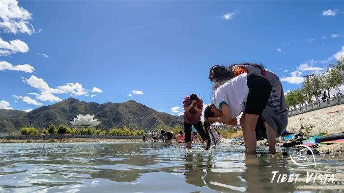 Wash hair in Lhasa river during the Bathing Festival.