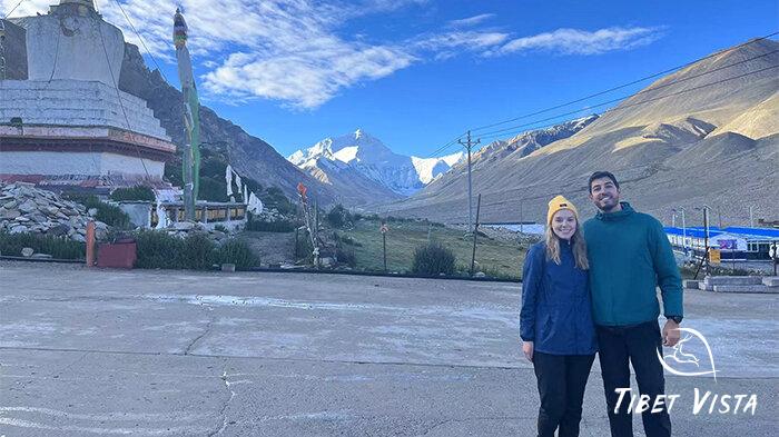 A foreign couple take photos at Mt.Everest.