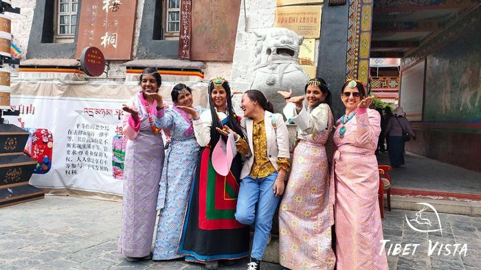 Group of tourists really enjoy their Tibet tour in Tibetan traditional dresses.