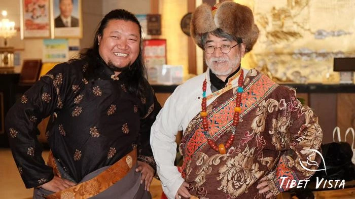 Tourists in traditional Tibetan dress take pictures with our guide Lhakpa at the party.