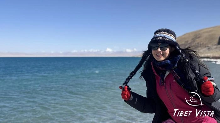 The blue waters of Namtso shimmering under the clear blue sky.