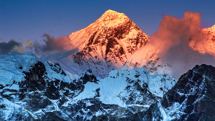 The radiance of the sunrise shines on Mount Everest