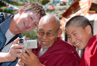 Showing photo on screen to monks in Samye